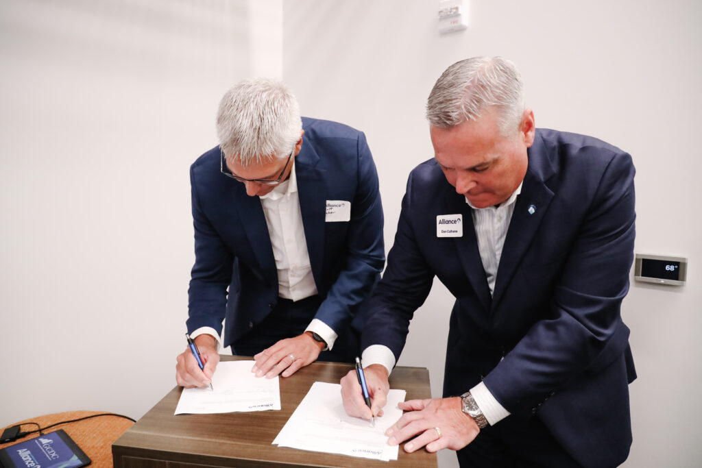 alliance members signing docs